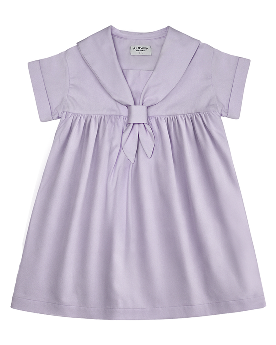 Lavender dress with a bow detail on a white background