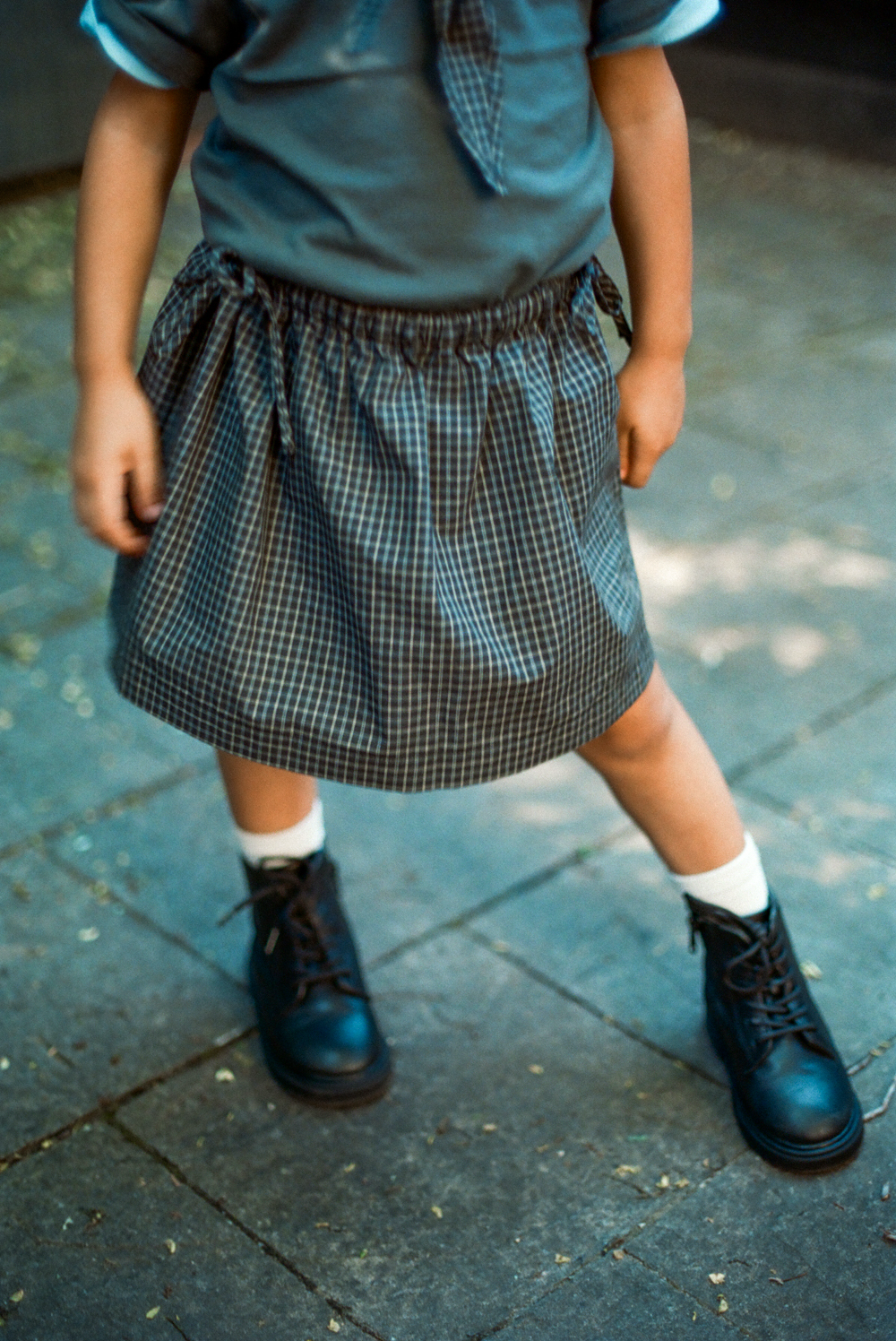 Young girl wearing a light blue skirt in natural land
